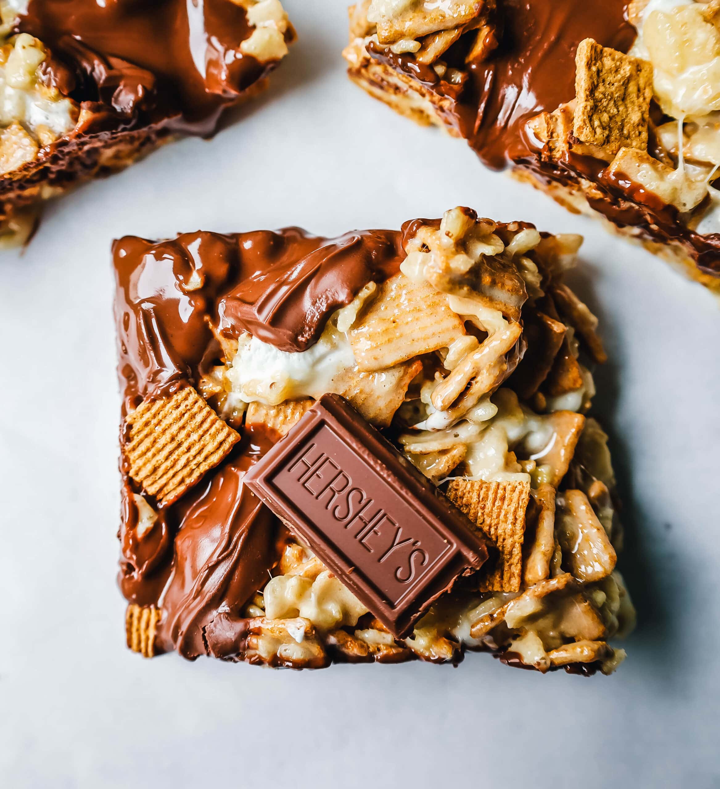 S'more Rice Krispie Treats made with Golden Graham, Rice Krispies, Marshmallows, Butter, and Hershey's Milk Chocolate Bars. The perfect S'more Rice Krispies that can be made in less than 15 minutes!