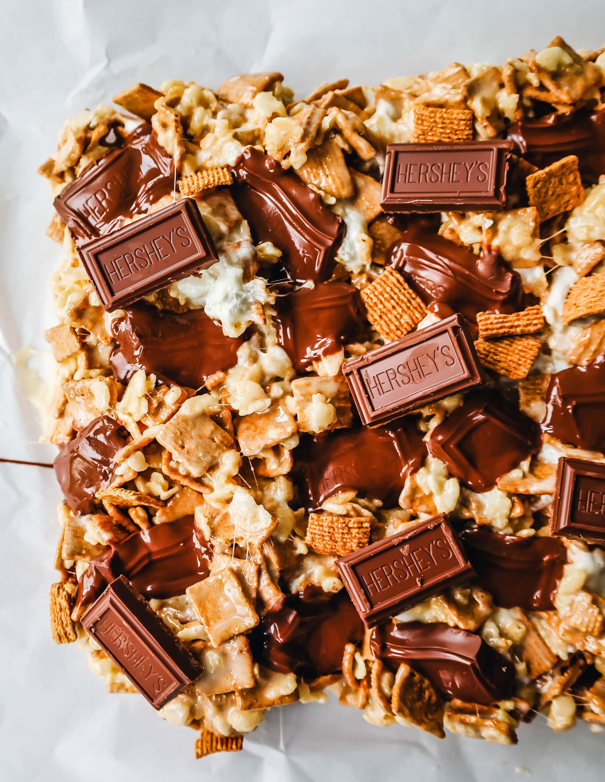 S'more Rice Krispie Treats made with Golden Graham, Rice Krispies, Marshmallows, Butter, and Hershey's Milk Chocolate Bars. The perfect S'more Rice Krispies that can be made in less than 15 minutes!