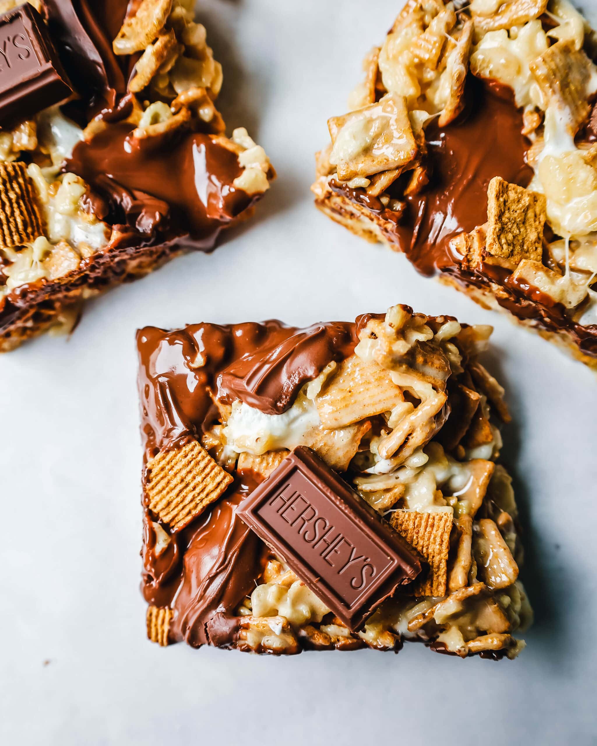 S'more Rice Krispie Treats made with Golden Graham, Rice Krispies, Marshmallows, Butter, and Hershey's Milk Chocolate Bars. The perfect S'more Rice Krispies that can be made in less than 15 minutes!