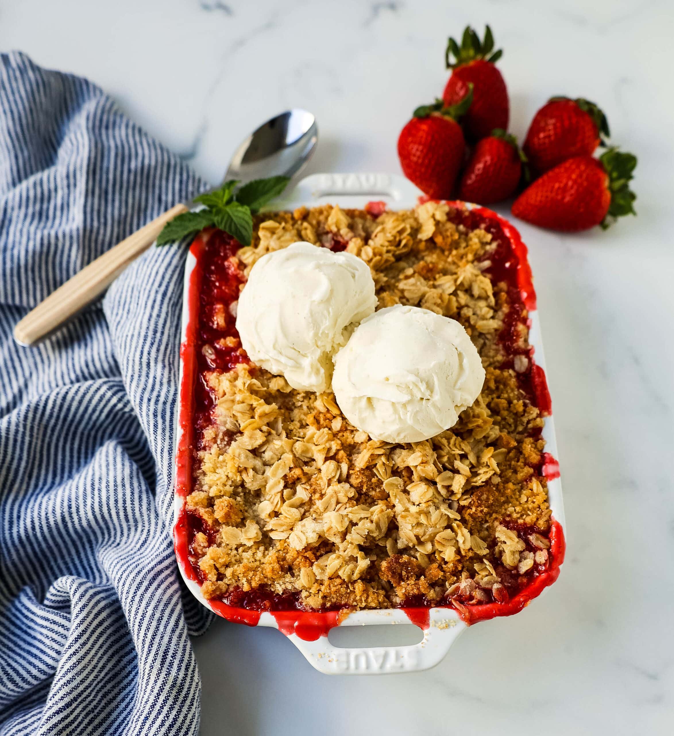 This Strawberry Crisp is made with fresh sweetened strawberries topped with a homemade buttery oat crumble topping. A Homemade Strawberry Crumble is an easy summer dessert. 