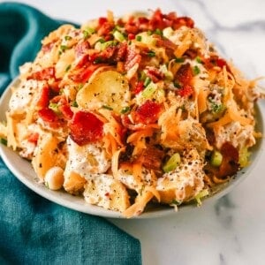 The Best Loaded Potato Salad Recipe is made with creamy gold potatoes, crispy bacon, cheddar cheese, green onions, sour cream, mayonnaise, seasoned salt, and pepper. The perfect baked potato salad recipe is perfect for your next party, potluck, or as a BBQ side dish.