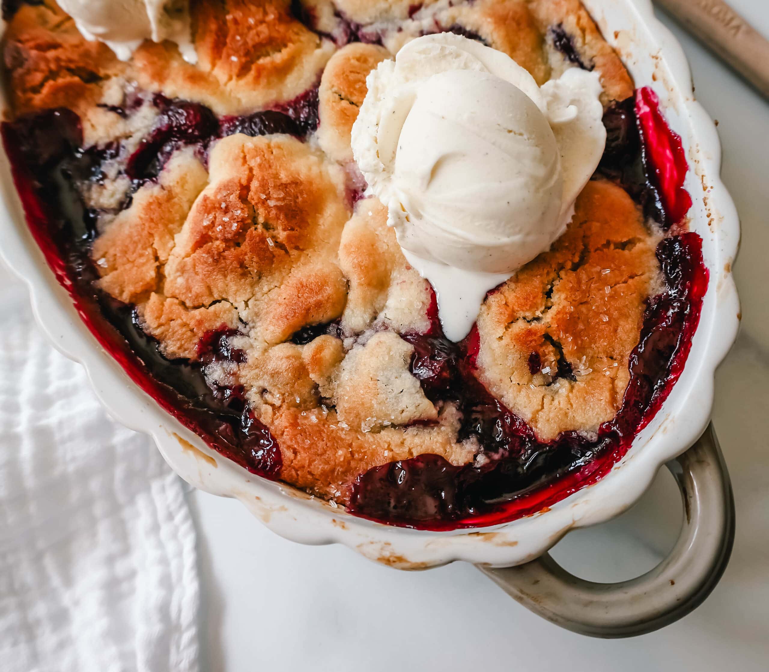 This is the best cherry cobbler recipe!  This old-fashioned cherry cobbler is made with fresh, lightly sweetened cherries and is topped with a sweet, buttery, homemade cobbler crust.  You will love this easy cherry cobbler recipe!