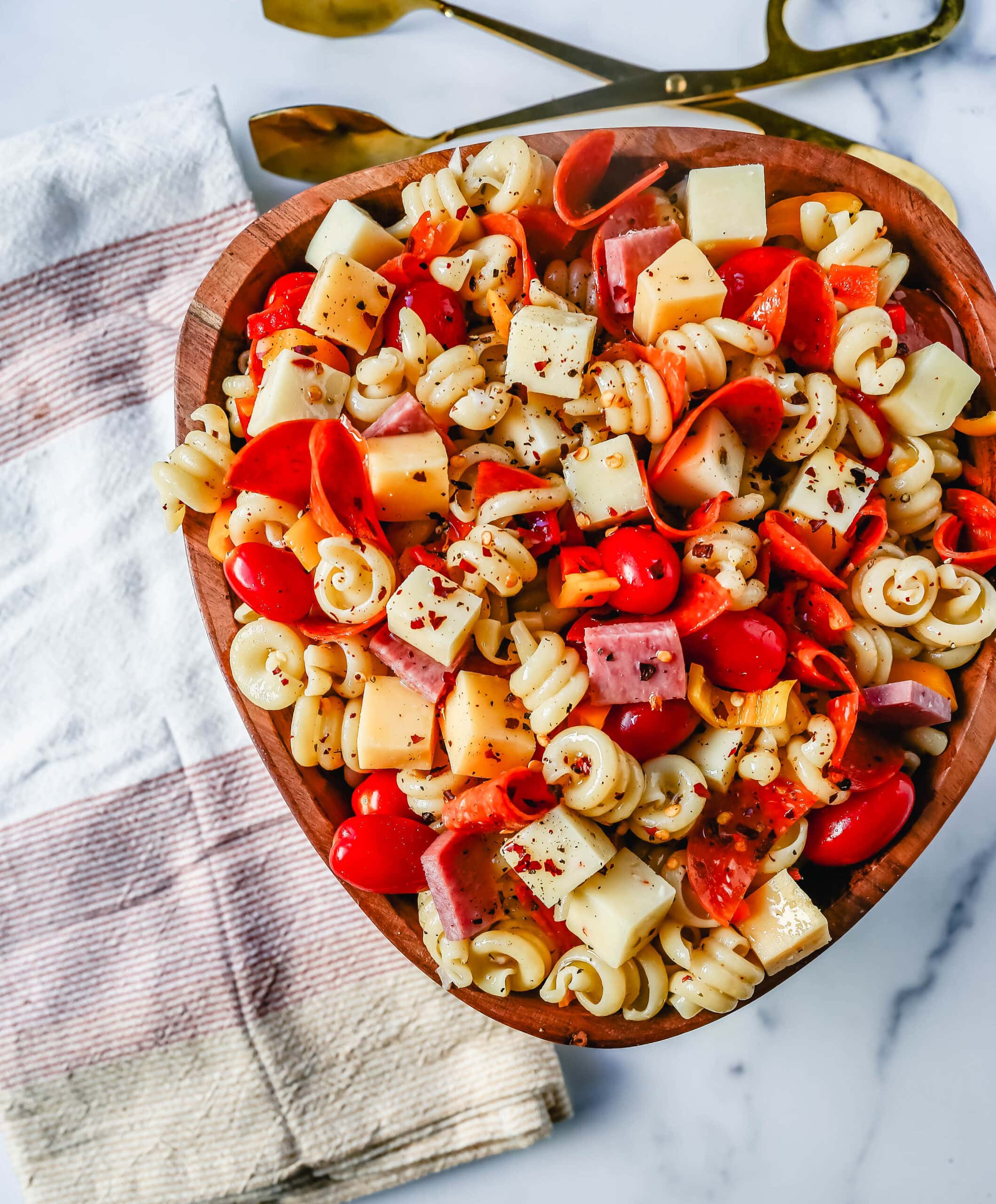 The best Classic Pasta Salad made with Italian meats, creamy cheeses, fresh vegetables, and all tossed in a creamy homemade Italian dressing. The perfect pasta salad recipe!