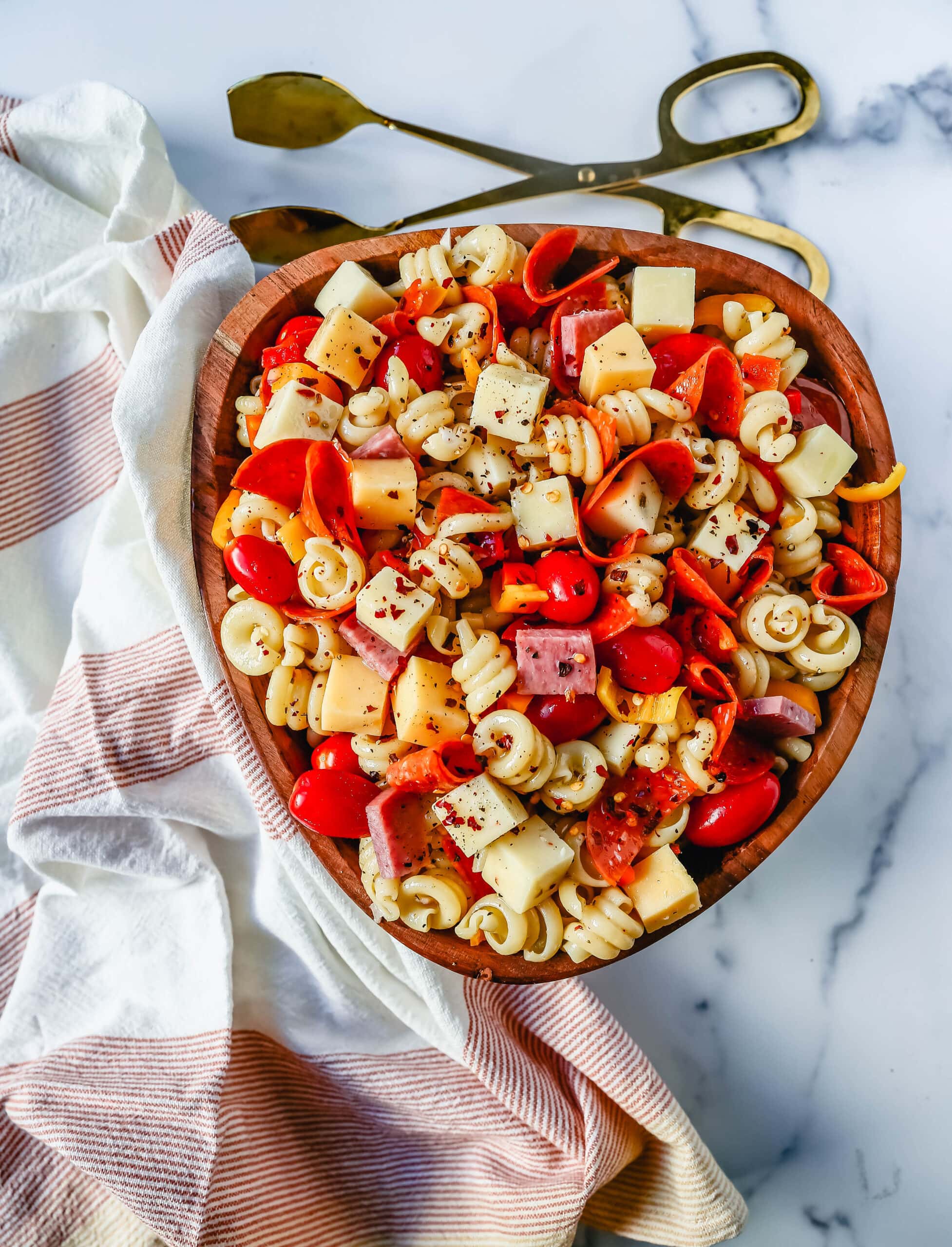 The best Classic Pasta Salad made with Italian meats, creamy cheeses, fresh vegetables, and all tossed in a creamy homemade Italian dressing. The perfect pasta salad recipe!