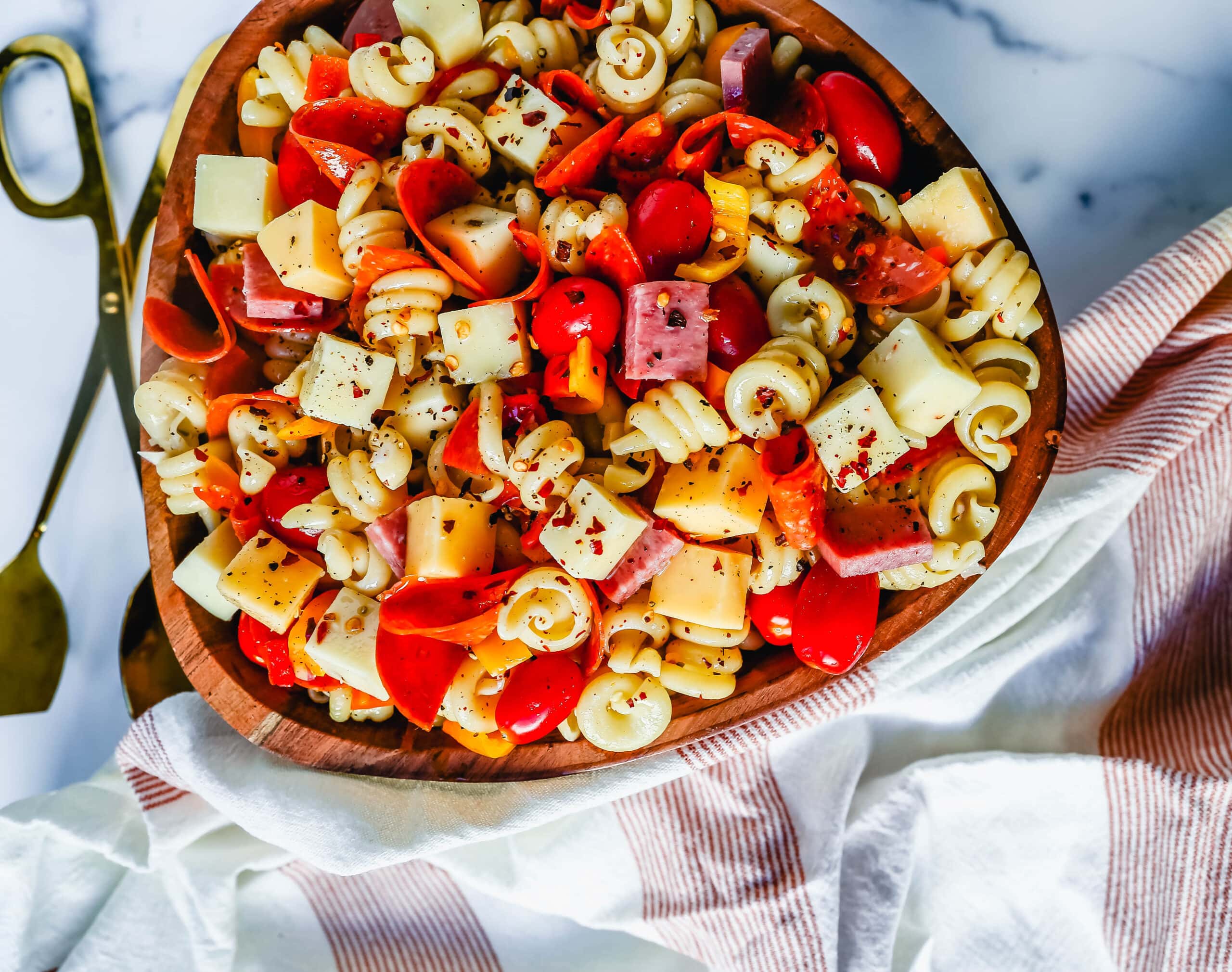 The best Classic Pasta Salad made with Italian meats, creamy cheeses, fresh vegetables, and all tossed in a creamy homemade Italian dressing. The perfect pasta salad recipe!