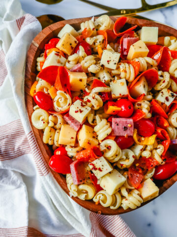 The best Classic Pasta Salad made with Italian meats, creamy cheeses, fresh vegetables, and all tossed in a creamy homemade Italian dressing. The perfect pasta salad recipe!