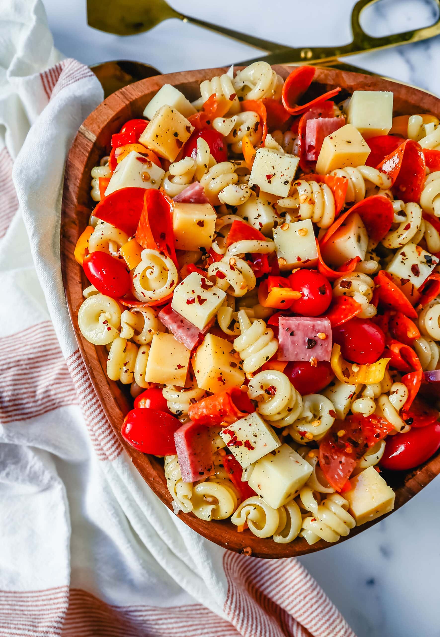 The best Classic Pasta Salad made with Italian meats, creamy cheeses, fresh vegetables, and all tossed in a creamy homemade Italian dressing. The perfect pasta salad recipe!