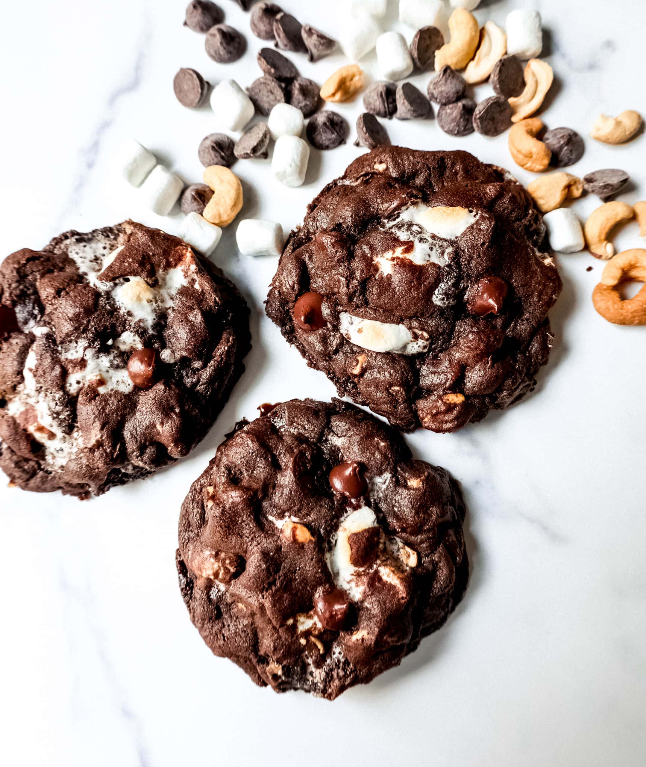 These Levain Bakery Rocky Road Cookies are rich, thick, soft, chewy chocolate cookies with semi-sweet chocolate chips, mini marshmallows, and cashews. The best Levain Bakery Copycat Rocky Road Cookie Recipe!