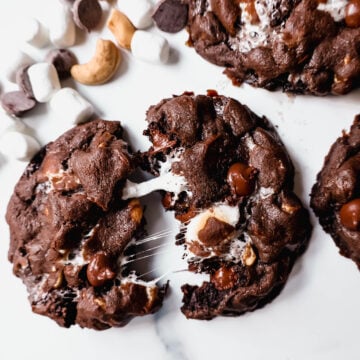 These Levain Bakery Rocky Road Cookies are rich, thick, soft, chewy chocolate cookies with semi-sweet chocolate chips, mini marshmallows, and cashews. The best Levain Bakery Copycat Rocky Road Cookie Recipe!