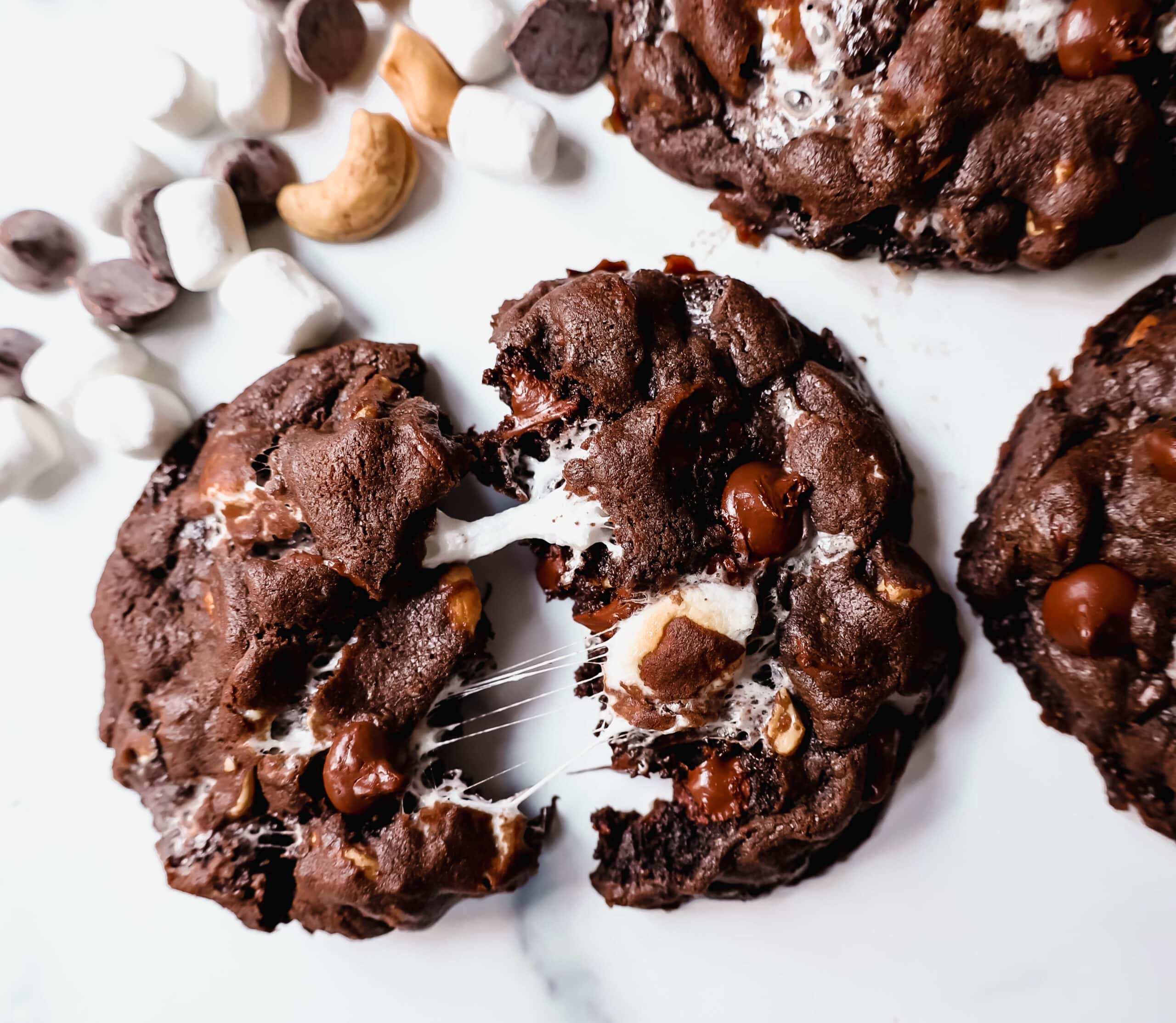 These Levain Bakery Rocky Road Cookies are rich, thick, soft, chewy chocolate cookies with semi-sweet chocolate chips, mini marshmallows, and cashews. The best Levain Bakery Copycat Rocky Road Cookie Recipe!