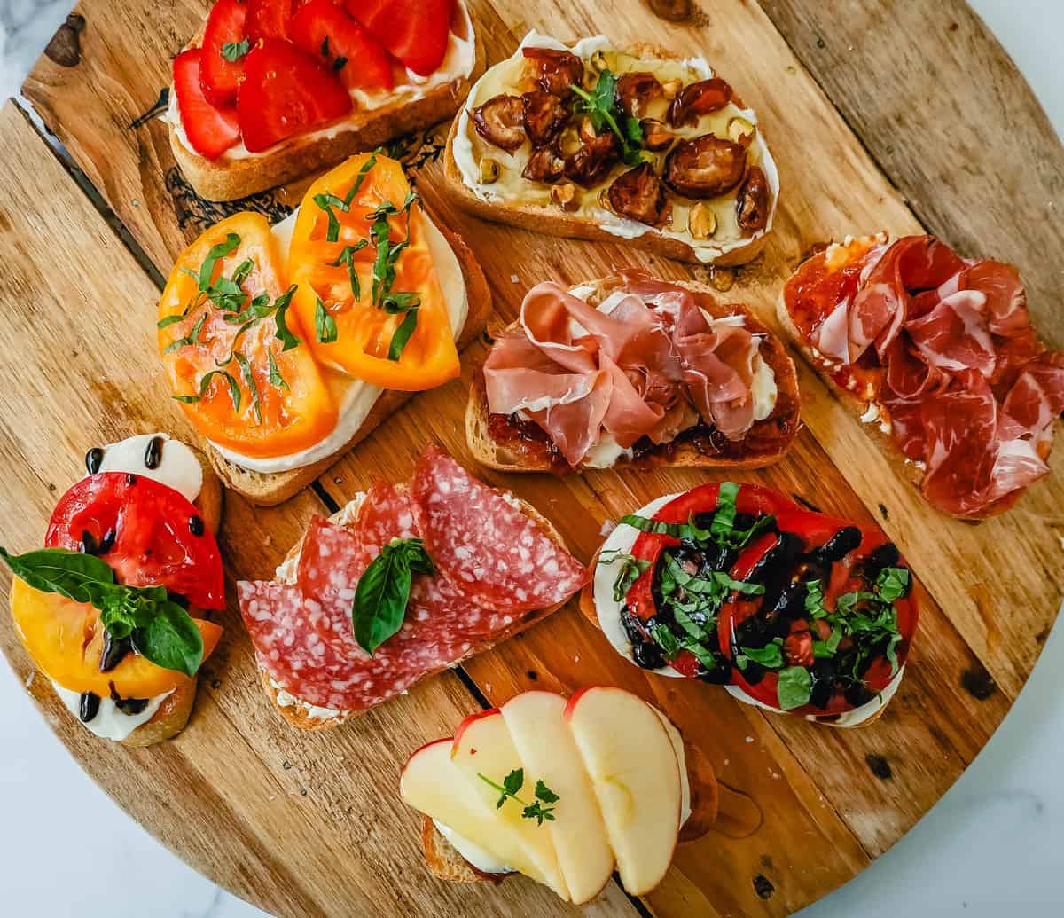 Bruschetta platter with grilled baguette rounds tomato basil and strawberry balsamic topping bowls for 4th of July potluck
