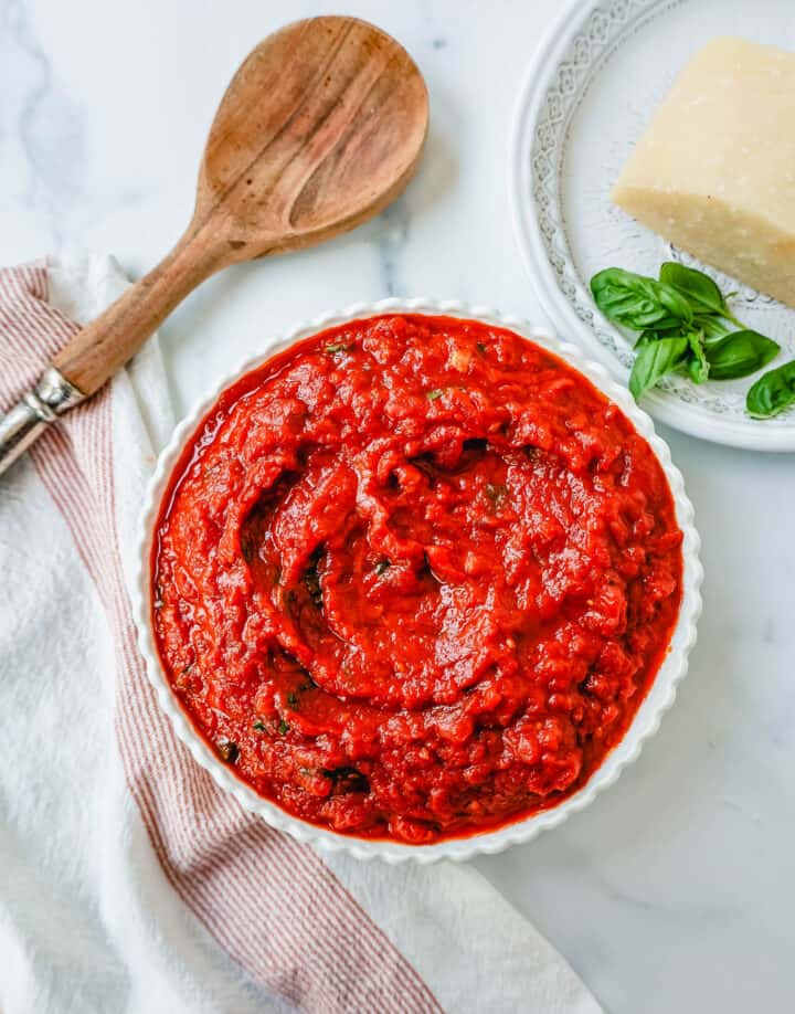This Marinara Sauce is the best tomato sauce recipe! This San Marzano Tomato Sauce is made with extra-virgin olive oil, garlic, San Marzano canned tomatoes, tomato paste, fresh herbs, and spices. This homemade marinara sauce simmers for hours to create the most robust and flavorful easy marinara sauce.