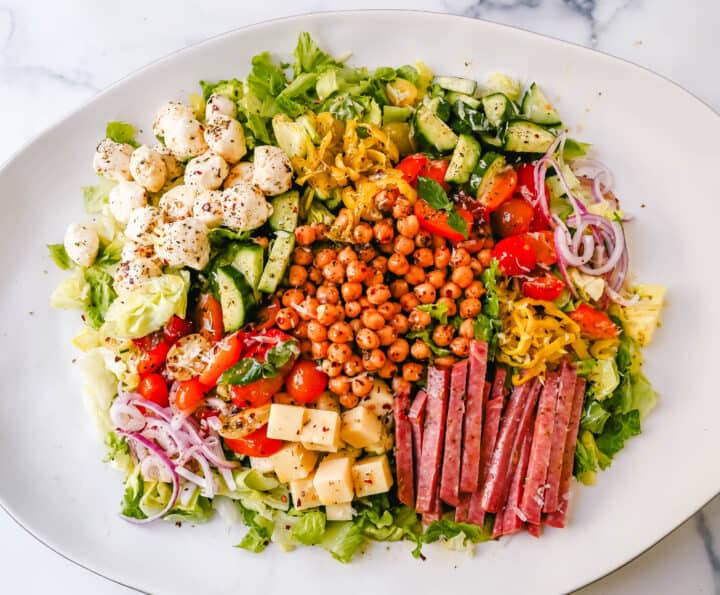 How to make the best Italian Chopped Salad made with Italian meats, cheeses, vegetables, and tossed with a homemade Italian dressing. This is the most flavor-packed salad recipe! This Italian Chop Salad is the perfect summer meal or side dish.