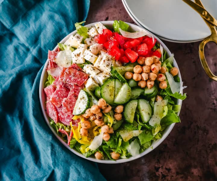 How to make the best Italian Chopped Salad made with Italian meats, cheeses, vegetables, and tossed with a homemade Italian dressing. This is the most flavor-packed salad recipe! This Italian Chop Salad is the perfect summer meal or side dish.