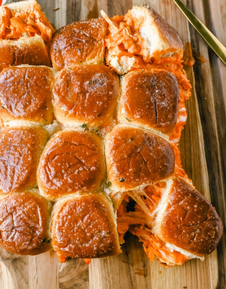 Buffalo Chicken Sliders are made with tender shredded chicken tossed in buffalo sauce and ranch dressing and baked inside a soft garlic butter bun with melted mozzarella cheese. The buffalo wing chicken sliders are perfect for watching football!