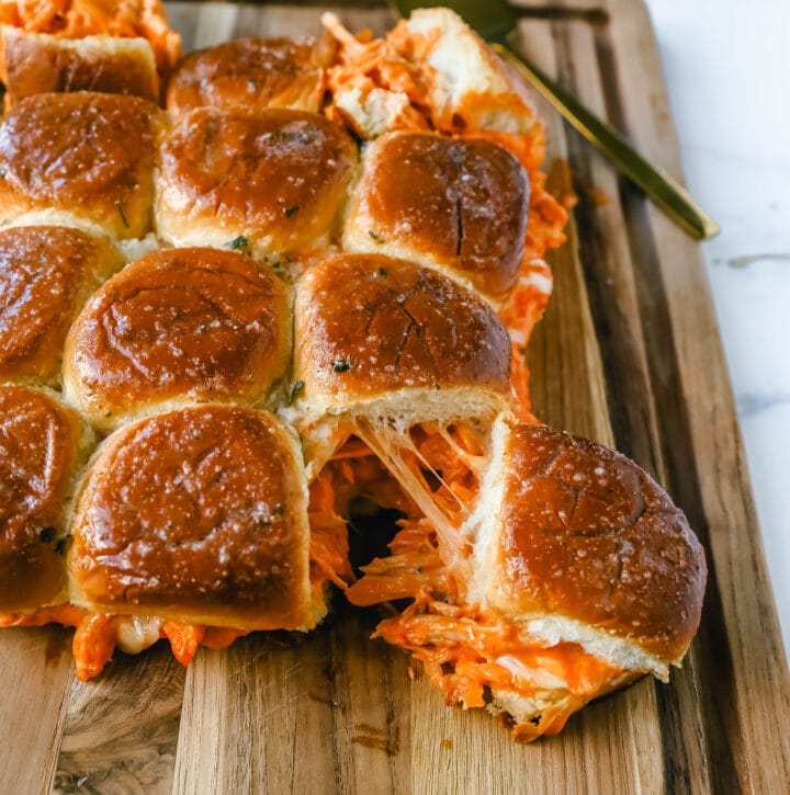 Buffalo Chicken Sliders are made with tender shredded chicken tossed in buffalo sauce and ranch dressing and baked inside a soft garlic butter bun with melted mozzarella cheese. The buffalo wing chicken sliders are perfect for watching football!
