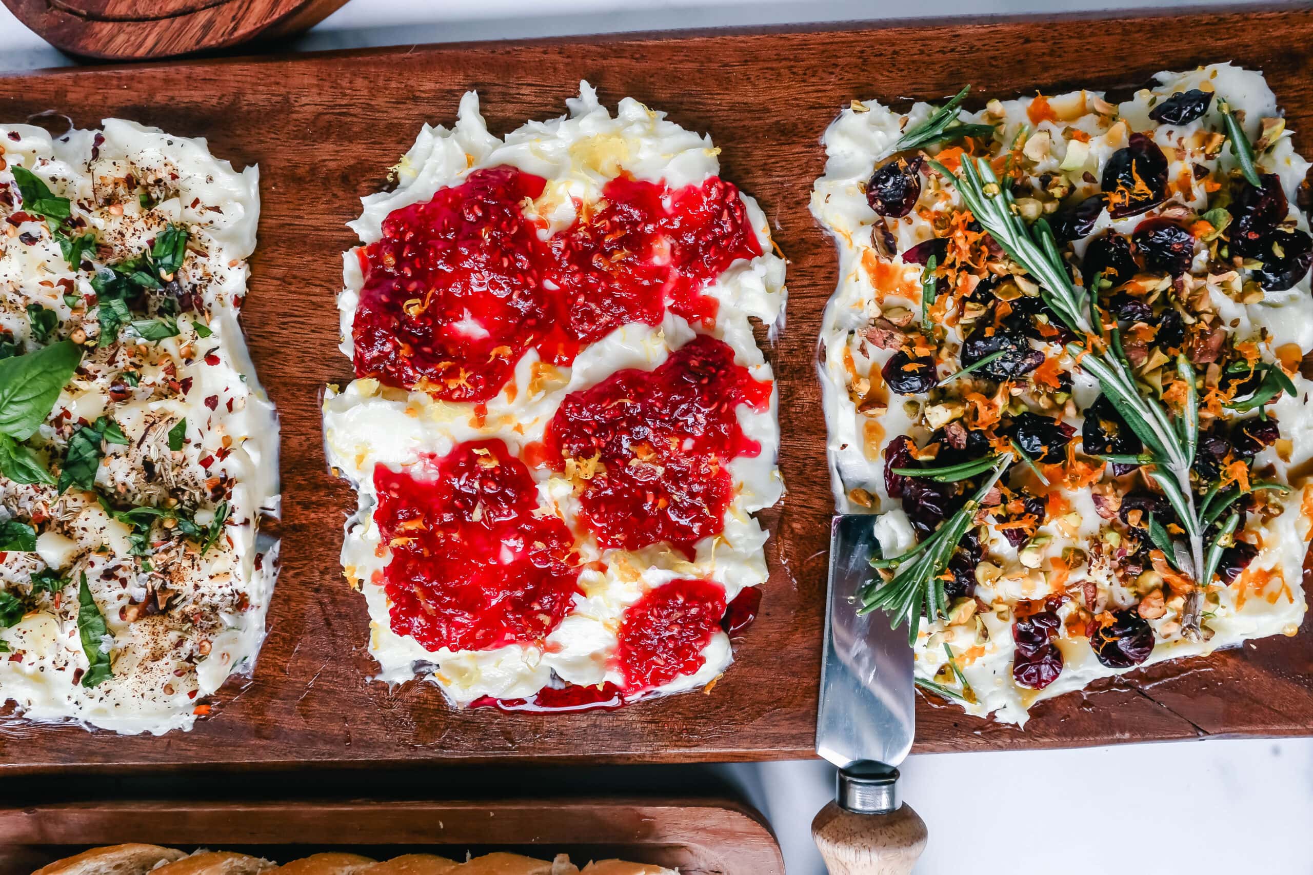  A Butter Board with fresh butter is spread onto a board and topped with an assortment of toppings and served with warm bread. This Butter Board with Toppings is such a fun appetizer for a party!