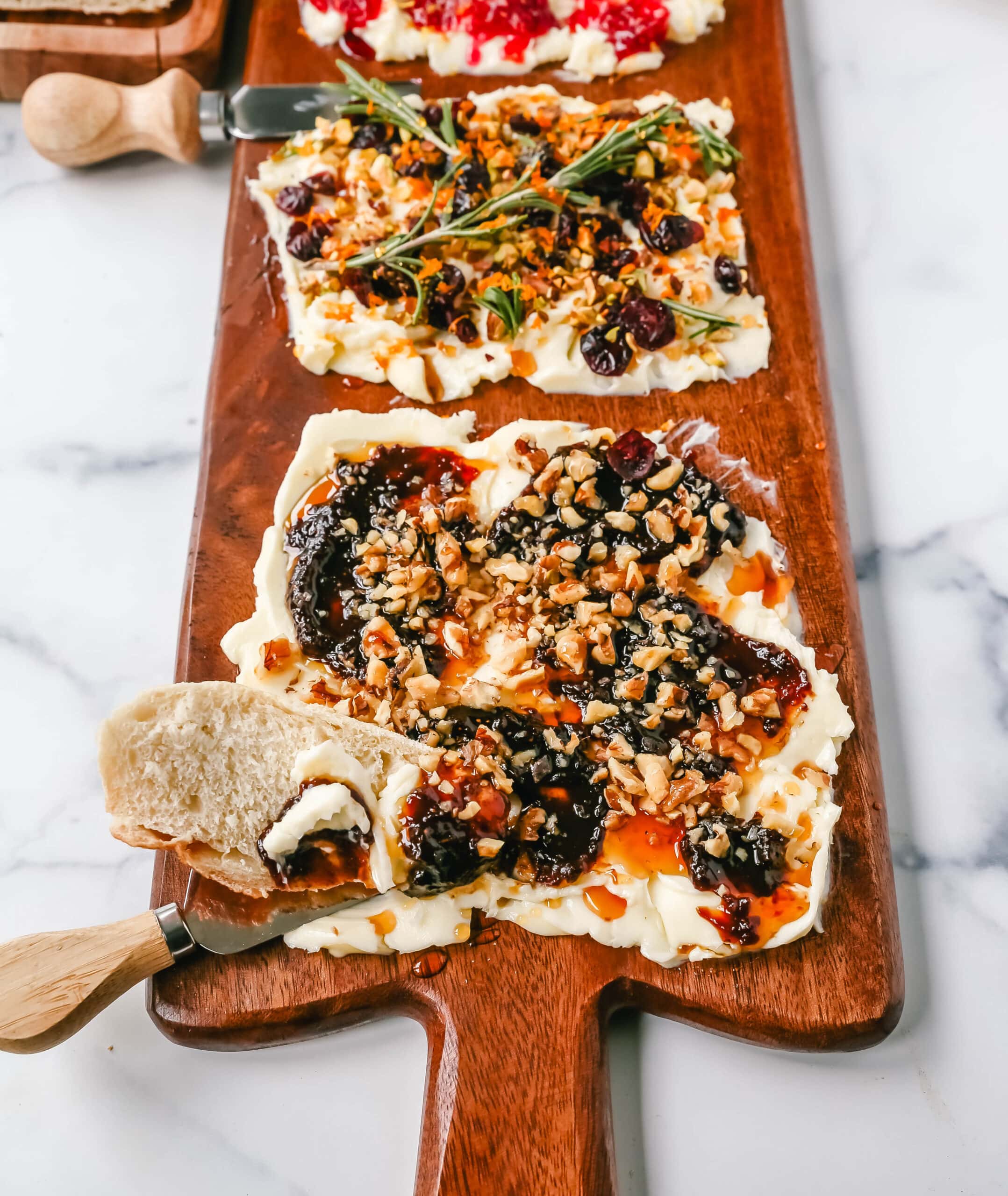  A Butter Board with fresh butter is spread onto a board and topped with an assortment of toppings and served with warm bread. This Butter Board with Toppings is such a fun appetizer for a party!