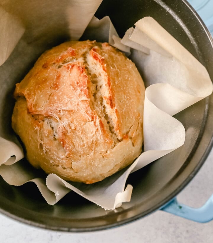 This No Knead Bread is baked in a dutch oven and is the perfect crusty french bread recipe. This makes a beautiful artisan loaf of bread and is so easy! The only ingredients you need are flour, water, salt, and yeast for the perfect overnight bread.