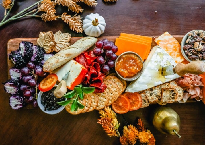 Festive Charcuterie Board perfect to celebrate Thanksgiving or Friendsgiving with friends and family. How to pick out the perfect meats, cheeses, fruits, jams, crackers, and dips for your Fall charcuterie spread. Tips and tricks for making the best charcuterie board.