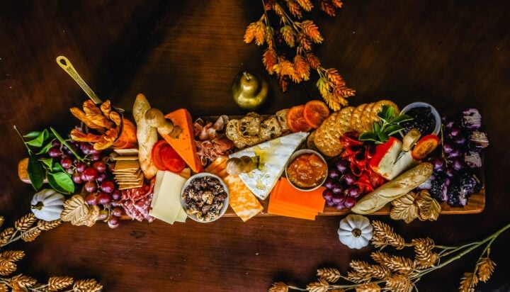 Festive Charcuterie Board perfect to celebrate Thanksgiving or Friendsgiving with friends and family. How to pick out the perfect meats, cheeses, fruits, jams, crackers, and dips for your Fall charcuterie spread. Tips and tricks for making the best charcuterie board.