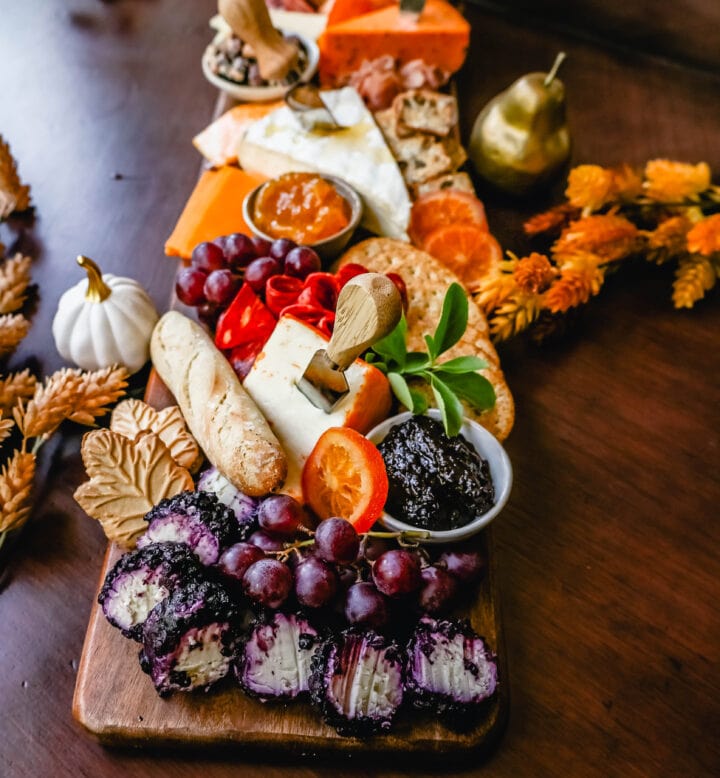 Festive Charcuterie Board perfect to celebrate Thanksgiving or Friendsgiving with friends and family. How to pick out the perfect meats, cheeses, fruits, jams, crackers, and dips for your Fall charcuterie spread. Tips and tricks for making the best charcuterie board.