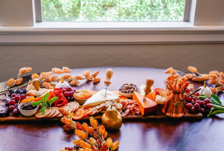 Festive Charcuterie Board perfect to celebrate Thanksgiving or Friendsgiving with friends and family. How to pick out the perfect meats, cheeses, fruits, jams, crackers, and dips for your Fall charcuterie spread. Tips and tricks for making the best charcuterie board.