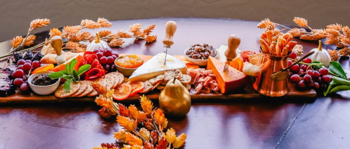 Festive Charcuterie Board perfect to celebrate Thanksgiving or Friendsgiving with friends and family. How to pick out the perfect meats, cheeses, fruits, jams, crackers, and dips for your Fall charcuterie spread. Tips and tricks for making the best charcuterie board.