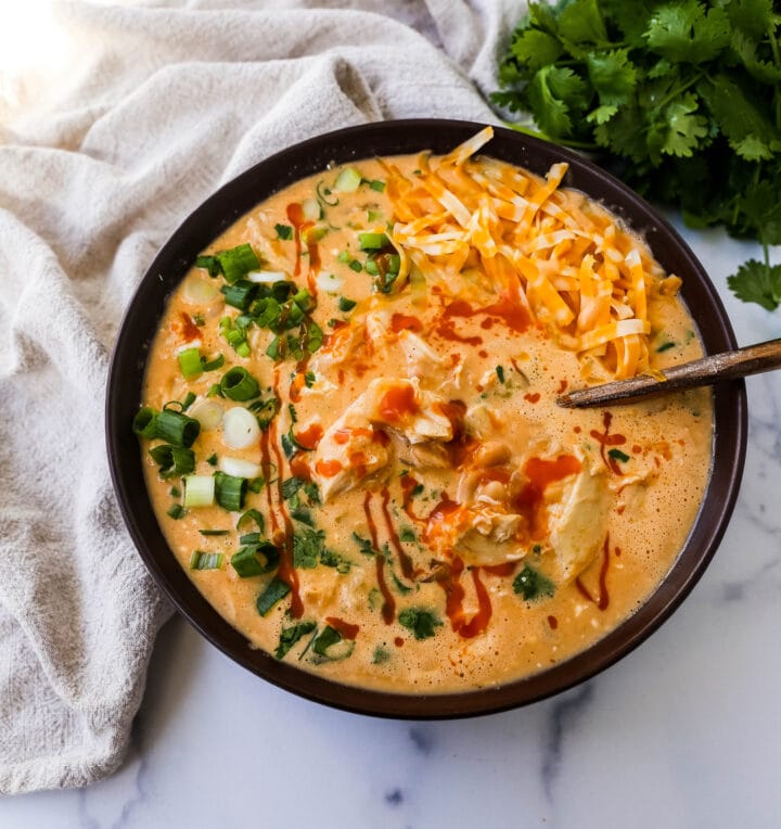 This Creamy Buffalo Chicken Chili is the perfect twist on a white chicken chili recipe. It is perfectly spiced, creamy, and has the right amount of tang. This will be your new favorite Buffalo white chicken chili recipe!