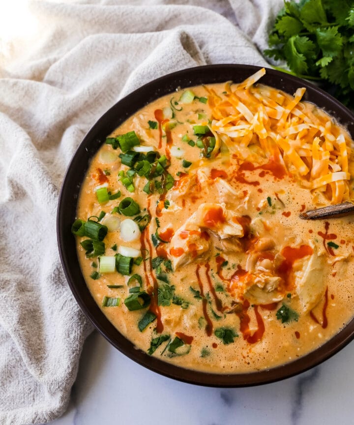 This Creamy Buffalo Chicken Chili is the perfect twist on a white chicken chili recipe. It is perfectly spiced, creamy, and has the right amount of tang. This will be your new favorite Buffalo white chicken chili recipe!