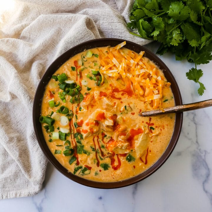 This Creamy Buffalo Chicken Chili is the perfect twist on a white chicken chili recipe. It is perfectly spiced, creamy, and has the right amount of tang. This will be your new favorite Buffalo white chicken chili recipe!