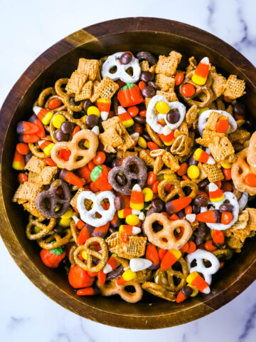 This Halloween Sweet and Salty Snack Mix is made with salty pretzels, butterscotch-tossed Chex cereal, candy corn, Reese's Pieces, and chocolate-covered pretzels. You can even add in some salty peanuts or caramel corn for a more salty and sweet combination. This is the perfect Fall sweet snack mix.