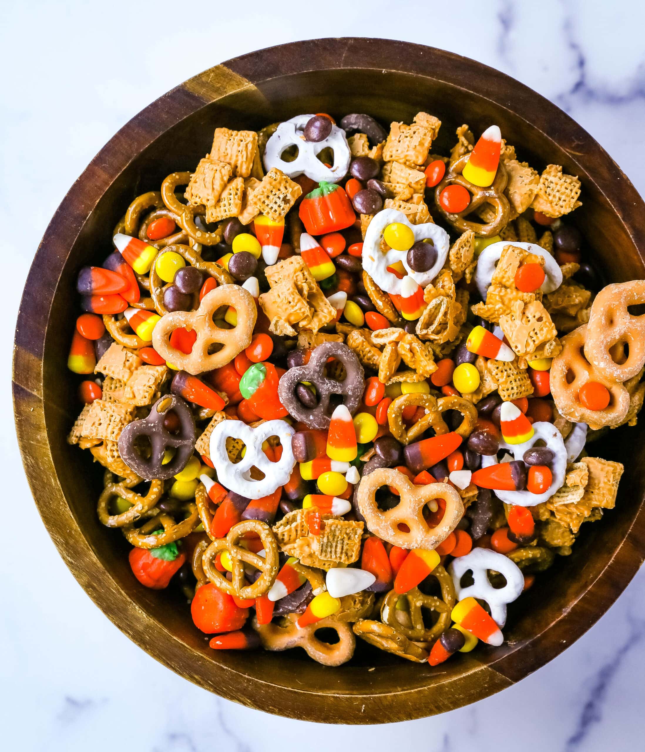 This Halloween Sweet and Salty Snack Mix is made with salty pretzels, butterscotch-tossed Chex cereal, candy corn, Reese's Pieces, and chocolate-covered pretzels. You can even add in some salty peanuts or caramel corn for a more salty and sweet combination. This is the perfect Fall sweet snack mix.