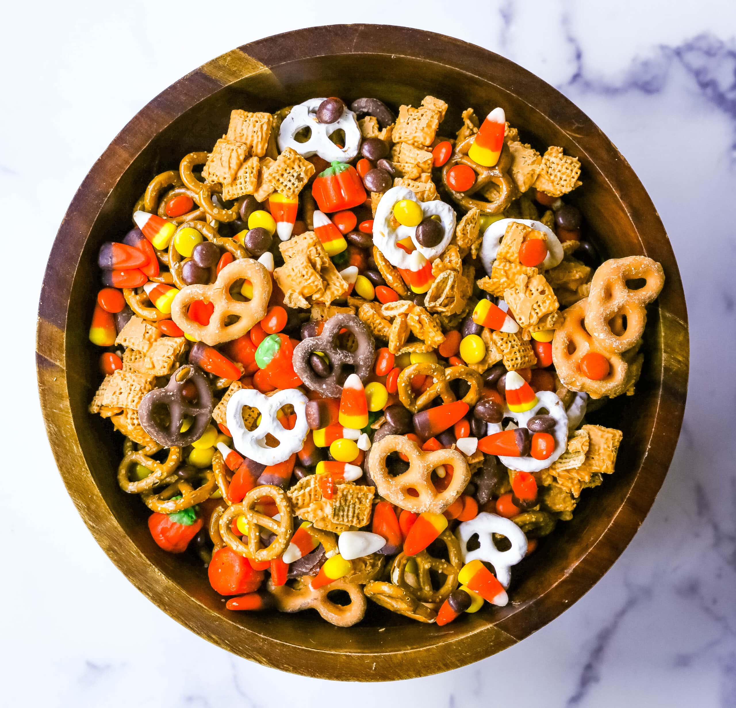 This Halloween Sweet and Salty Snack Mix is made with salty pretzels, butterscotch-tossed Chex cereal, candy corn, Reese's Pieces, and chocolate-covered pretzels. You can even add in some salty peanuts or caramel corn for a more salty and sweet combination. This is the perfect Fall sweet snack mix.