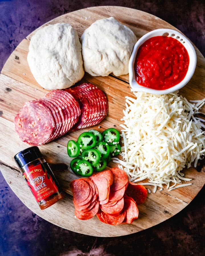 Homemade Pizza Ingredients. Homemade Pepperoni Jalapeno Hot Honey Pizza. Pepperoni Pizza with Hot Honey and Red Chili Flakes. How to make the best homemade pepperoni pizza at home with homemade pizza dough that makes the perfect crispy yet chewy crust. Tips and tricks for making gourmet pizza at home!