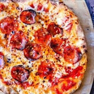 Pepperoni Pizza with Hot Honey and Red Chili Flakes. How to make the best homemade pepperoni pizza at home with homemade pizza dough that makes the perfect crispy yet chewy crust. Tips and tricks for making gourmet pizza at home!