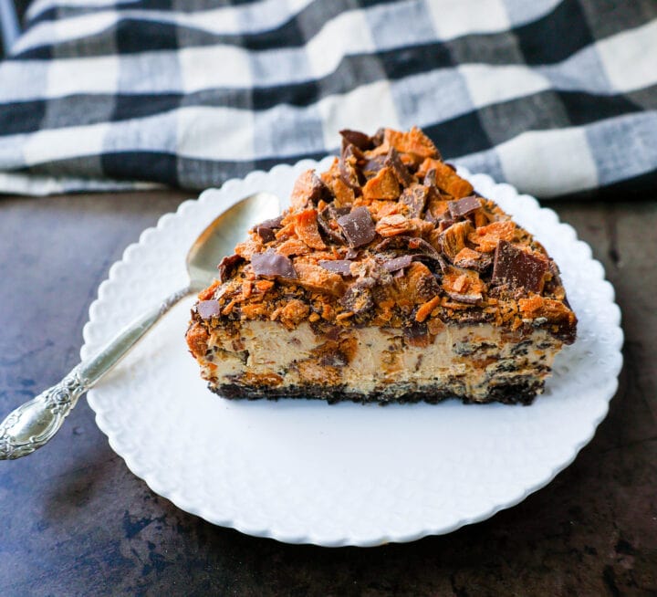 No-Bake Chocolate Peanut Butter Butterfinger Pie with a chocolate OREO crust, creamy peanut butter filling with Butterfinger candy bars, chocolate ganache, and topped with fresh whipped cream and Butterfinger. The best creamy Butterfinger pie recipe!