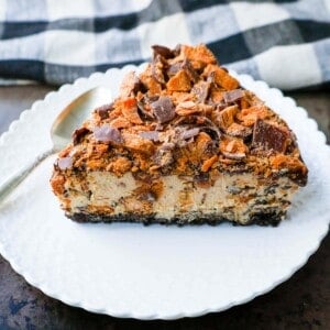 No-Bake Chocolate Peanut Butter Butterfinger Pie with a chocolate OREO crust, creamy peanut butter filling with Butterfinger candy bars, chocolate ganache, and topped with fresh whipped cream and Butterfinger. The best creamy Butterfinger pie recipe!