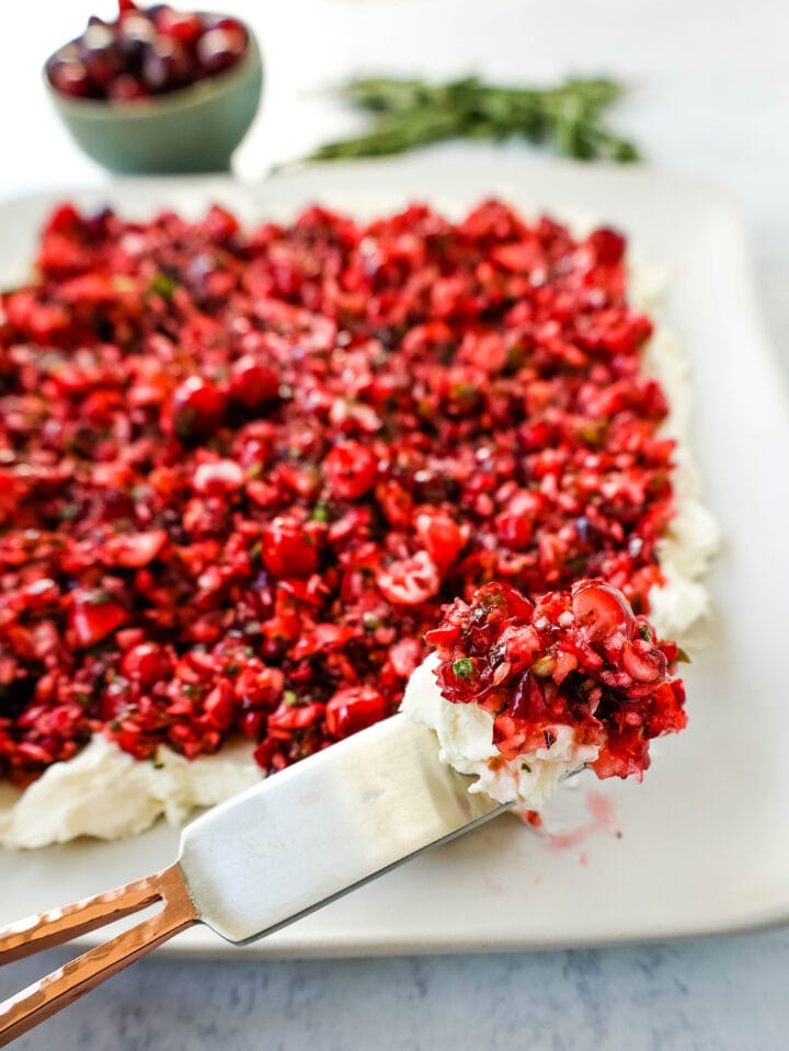 This Cranberry Jalapeno Cream Cheese Dip is a festive appetizer that is creamy, tart, a tad spicy, and sweet. This Cranberry Jalapeno Dip is made with fresh cranberry salsa atop cream cheese. It is the perfect holiday party appetizer!