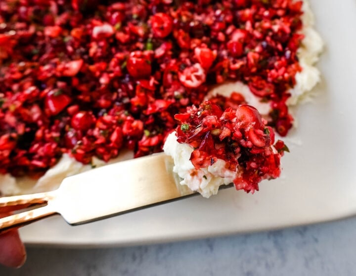 This Cranberry Jalapeno Cream Cheese Dip is a festive appetizer that is creamy, tart, a tad spicy, and sweet. This Cranberry Jalapeno Dip is made with fresh cranberry salsa atop cream cheese. It is the perfect holiday party appetizer!