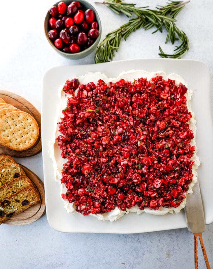 This Cranberry Jalapeno Cream Cheese Dip is a festive appetizer that is creamy, tart, a tad spicy, and sweet. This Cranberry Jalapeno Dip is made with fresh cranberry salsa atop cream cheese. It is the perfect holiday party appetizer!