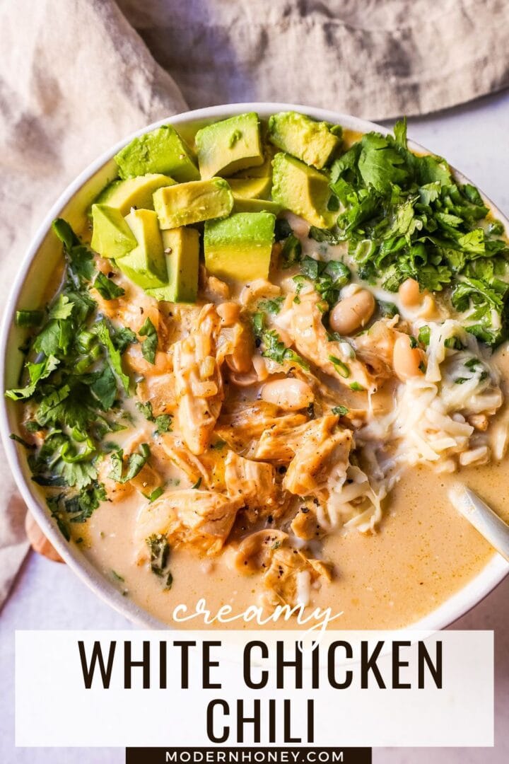 The Best White Chicken Chili Recipe made with shredded chicken, jalapeno, onion, spices, in a creamy chicken broth with salsa verde, cream cheese, white beans, shredded cheese, and fresh cilantro. The perfect creamy white chicken chili recipe!