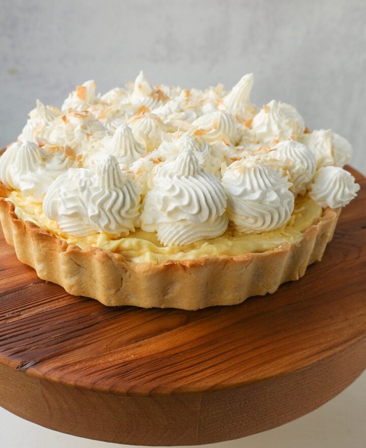 Easy Homemade Coconut Cream Pie made with pudding mix, sweetened condensed milk, whole milk, whipped cream, and sweetened shredded coconut all in a buttery pie crust and topped with sweet whipped cream. This is the best coconut cream pie recipe!