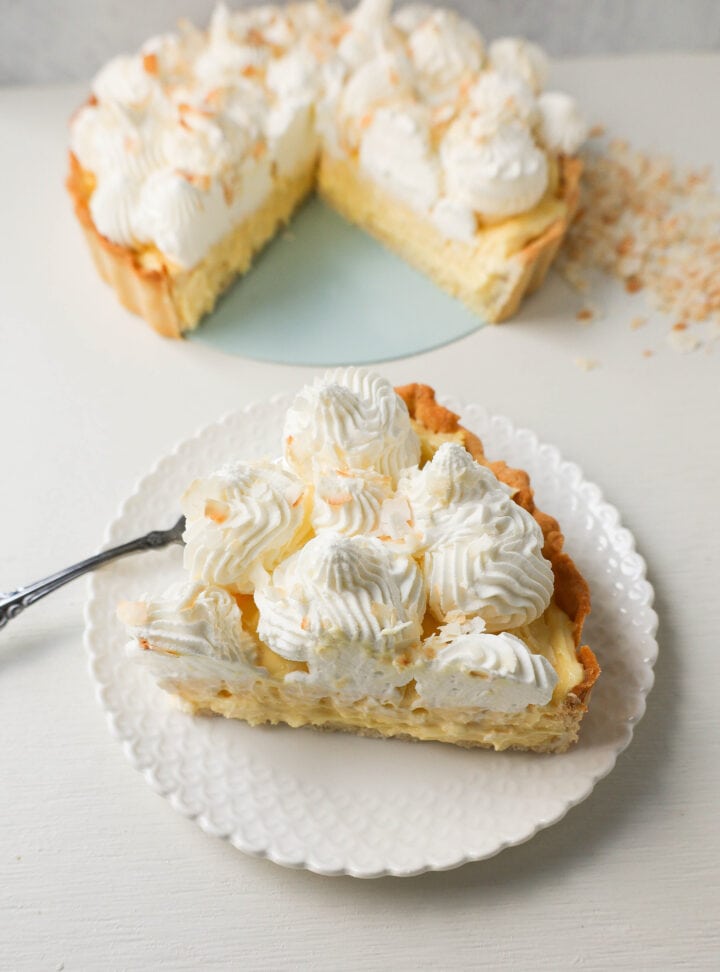 Easy Homemade Coconut Cream Pie made with pudding mix, sweetened condensed milk, whole milk, whipped cream, and sweetened shredded coconut all in a buttery pie crust and topped with sweet whipped cream. This is the best coconut cream pie recipe!
