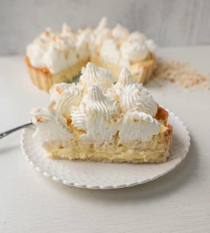 Easy Homemade Coconut Cream Pie made with pudding mix, sweetened condensed milk, whole milk, whipped cream, and sweetened shredded coconut all in a buttery pie crust and topped with sweet whipped cream. This is the best coconut cream pie recipe!