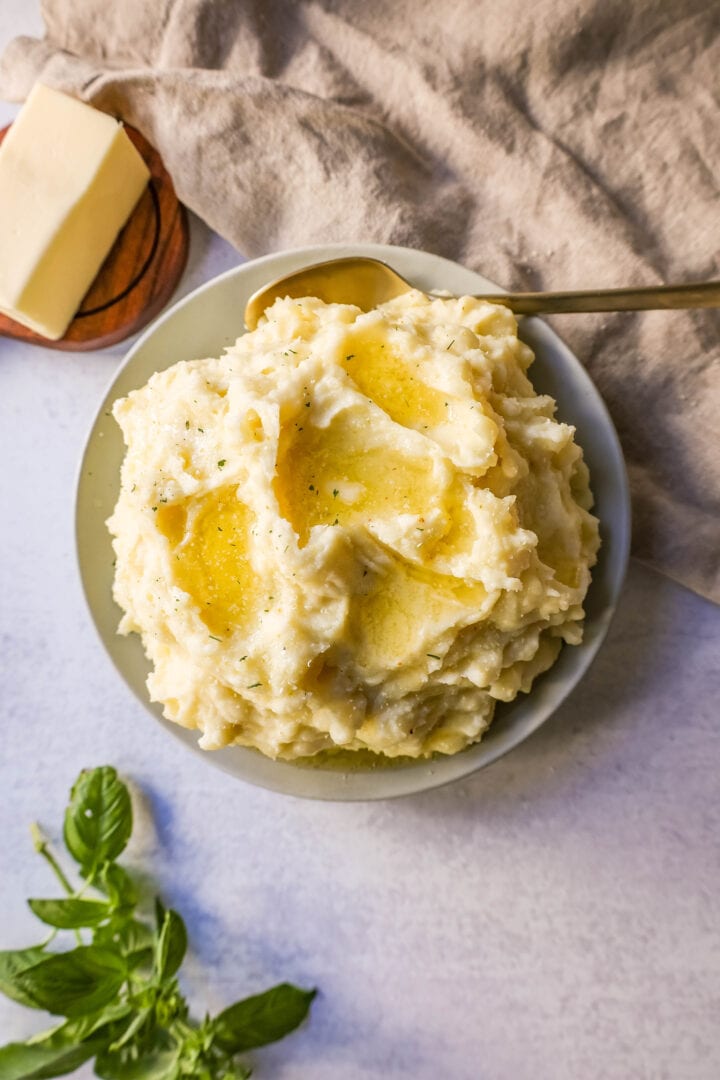 Creamy, Buttery Garlic Mashed Potatoes made with potatoes creamed with butter, garlic, mascarpone cheese, cream, and salt. The creamiest garlic mashed potatoes recipe!