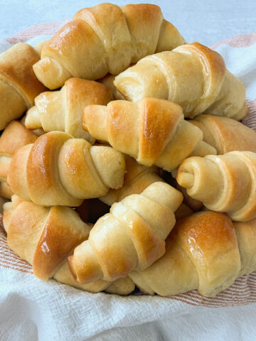 These Homemade Crescent Rolls are the most perfect buttery, light, and fluffy homemade roll recipe. Easy homemade rolls made from scratch!