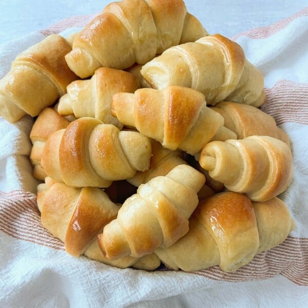 These Homemade Crescent Rolls are the most perfect buttery, light, and fluffy homemade roll recipe. Easy homemade rolls made from scratch!