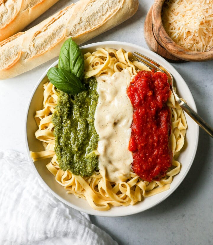 This Christmas Pasta is made with three popular sauces -- alfredo sauce, marinara sauce, and pesto sauce -- all tossed together with pasta. This Alfredo, Marinara, and Pesto Sauce Pasta is a surefire hit!