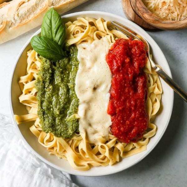 This Christmas Pasta is made with three popular sauces -- alfredo sauce, marinara sauce, and pesto sauce -- all tossed together with pasta. This Alfredo, Marinara, and Pesto Sauce Pasta is a surefire hit!